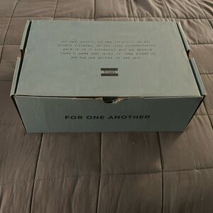 Tom’s black suede/veg tan leather sandal.